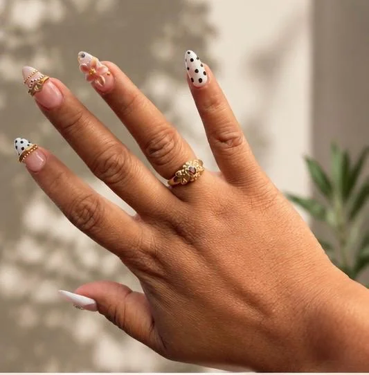 Soft Gel Nail Extensions na may white tips, black polka dots, gold bangle-style details, at floral accents.